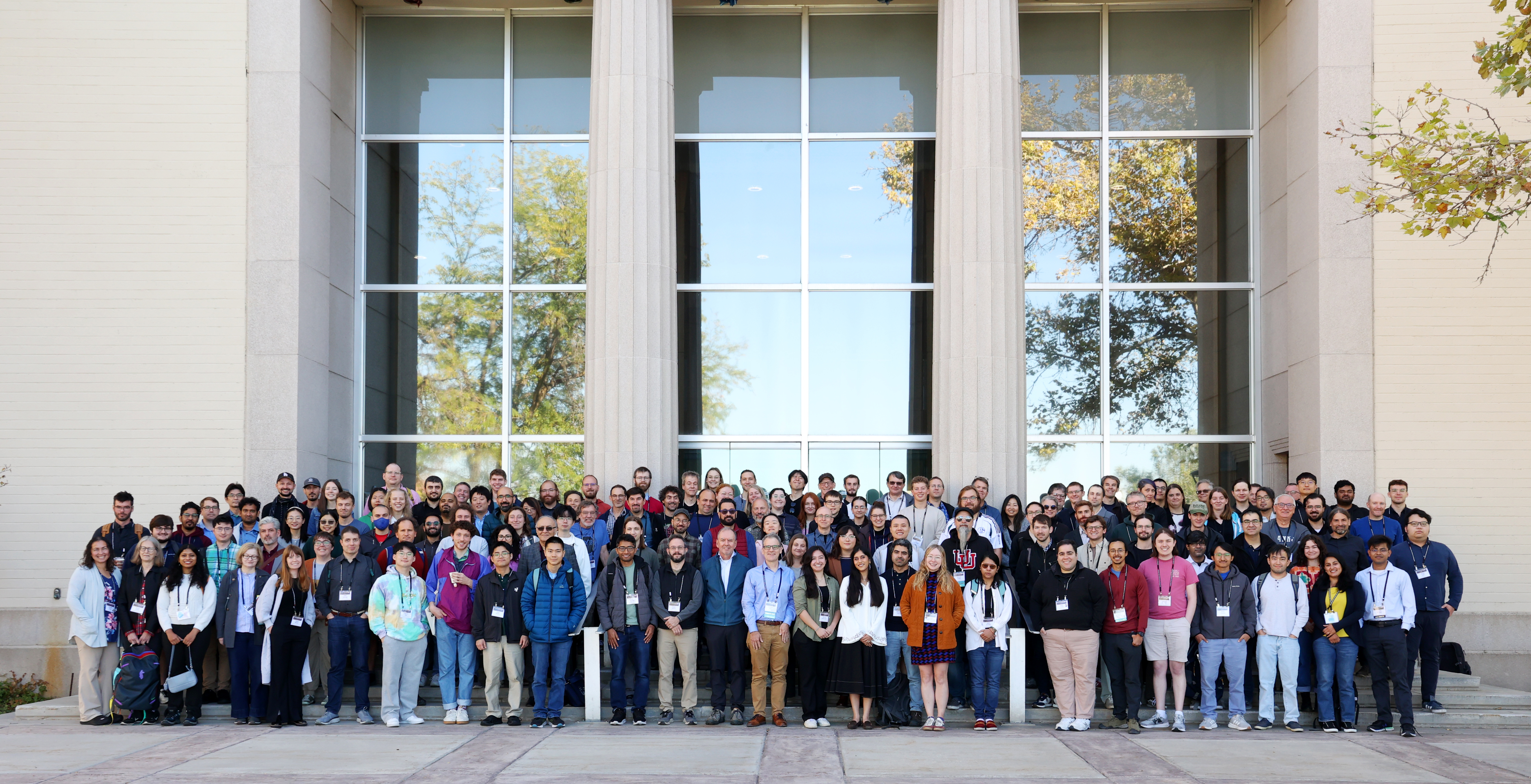 A group of people in front of a building posing for a photo